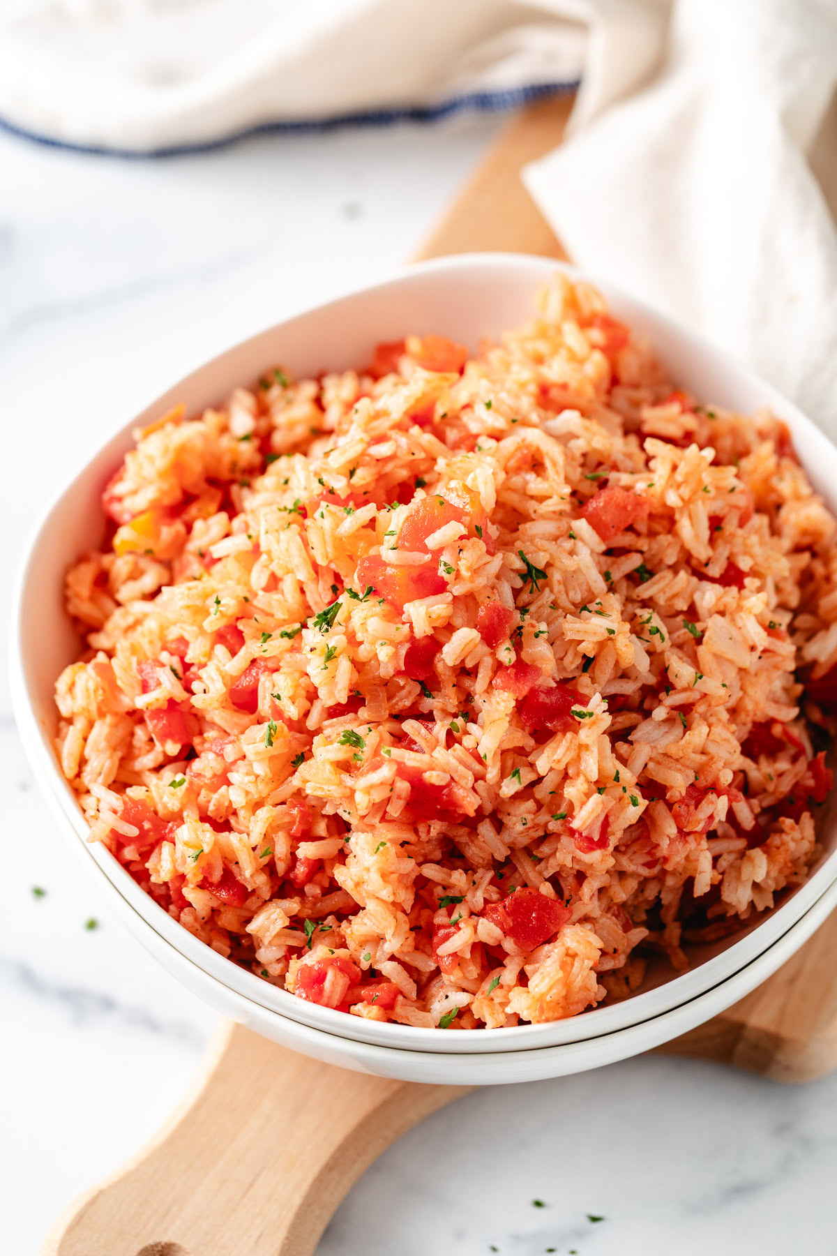 Savory white rice and tomatoes in a bowl.