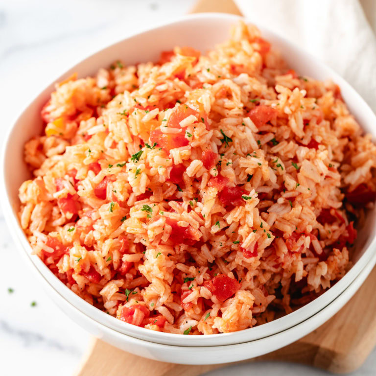 Tomatoes and rice in a white bowl.