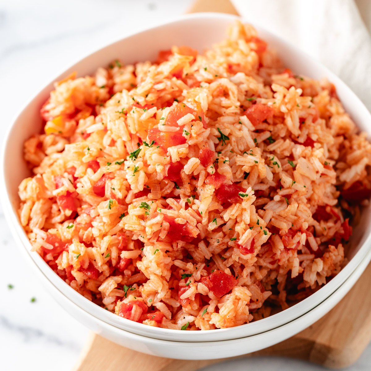 Tomatoes and rice in a white bowl.