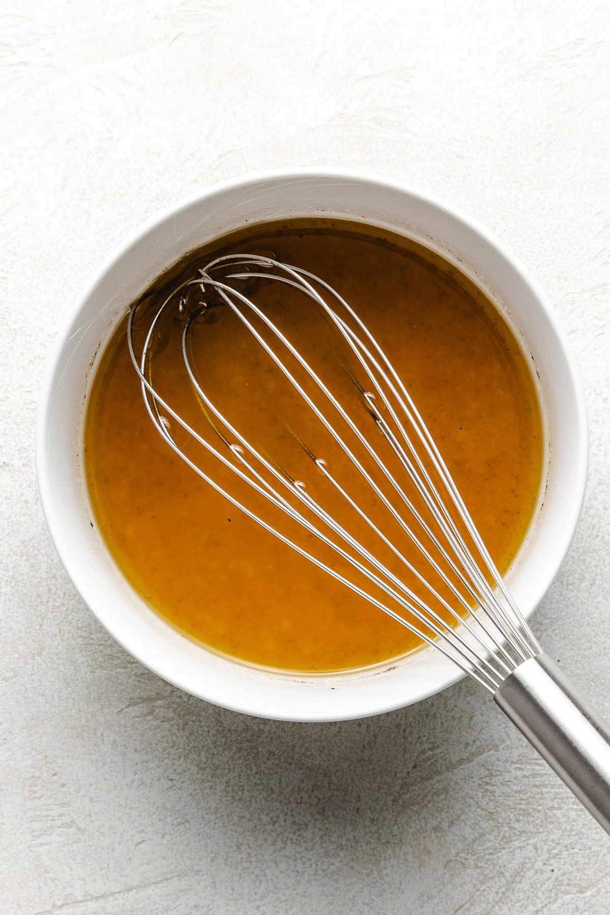 Apple cider vinaigrette in a white bowl.