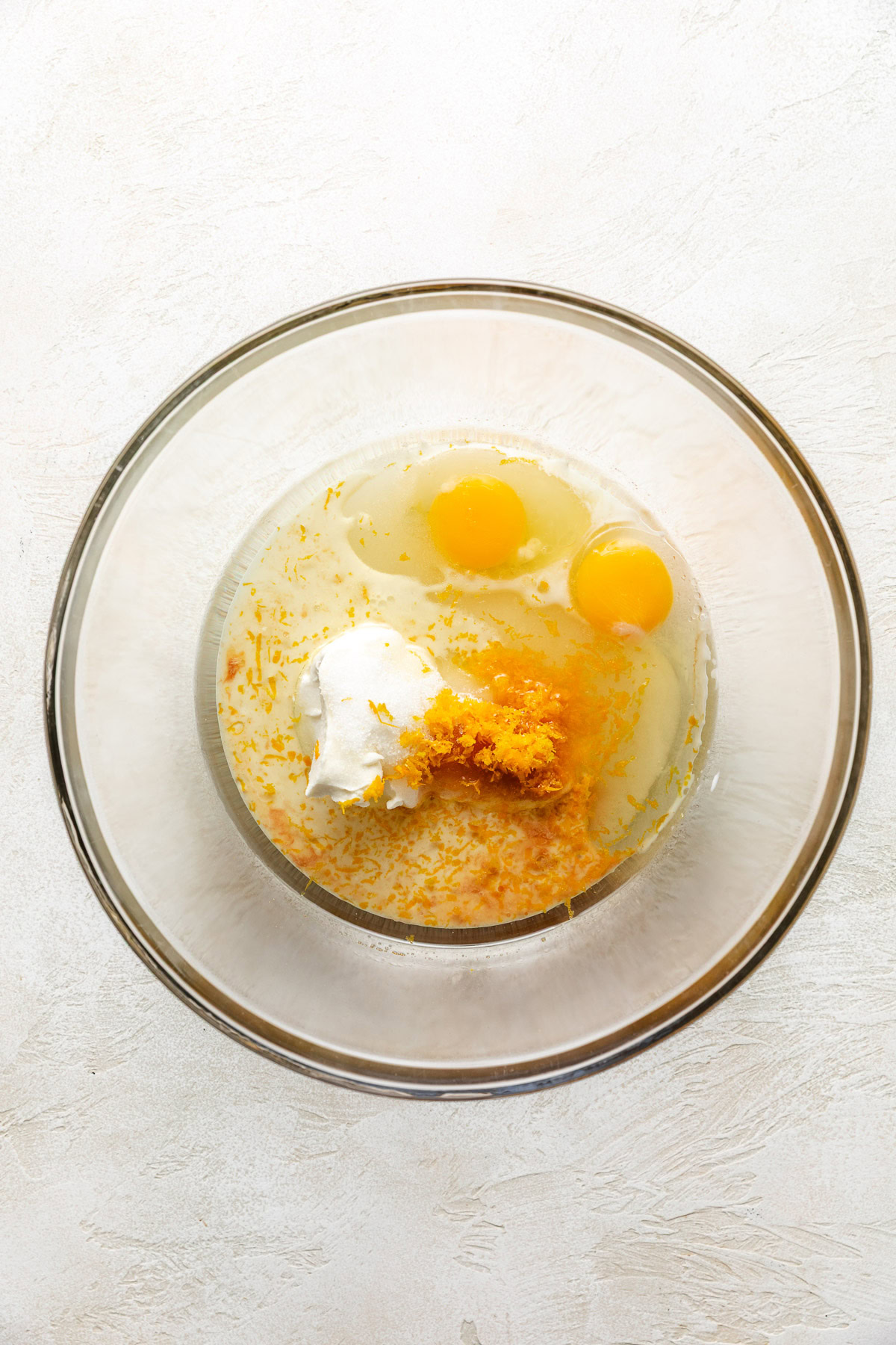 Cranberry Nut Bread Eggs, sugar, orange zest, and oil in a bowl.