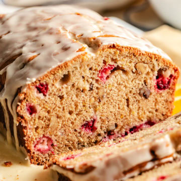Cranberry Nut Bread Close up view of a loaf of cranberry nut bread with sweet glaze.