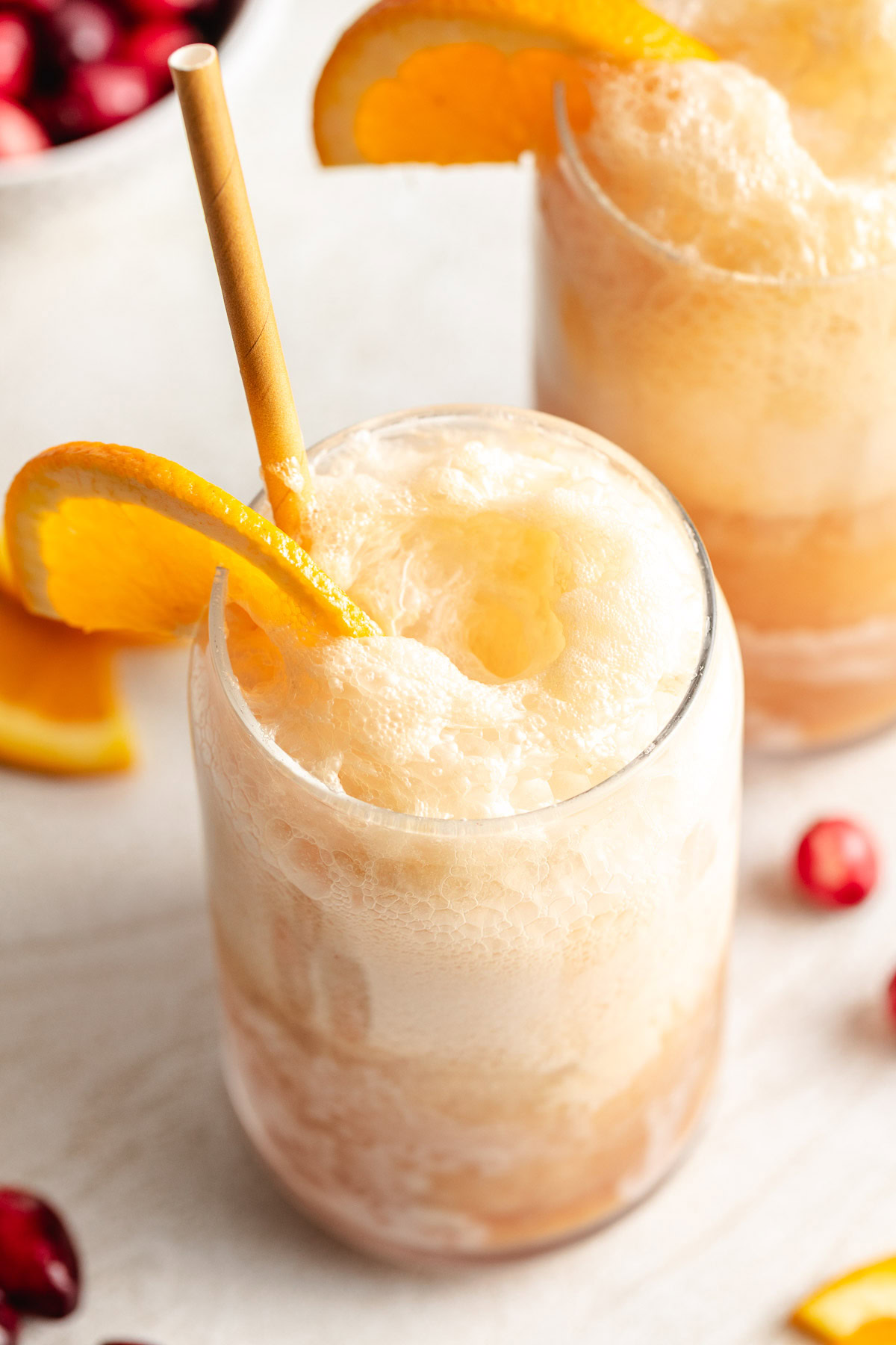 Cranberry orange ice cream soda with fizz.