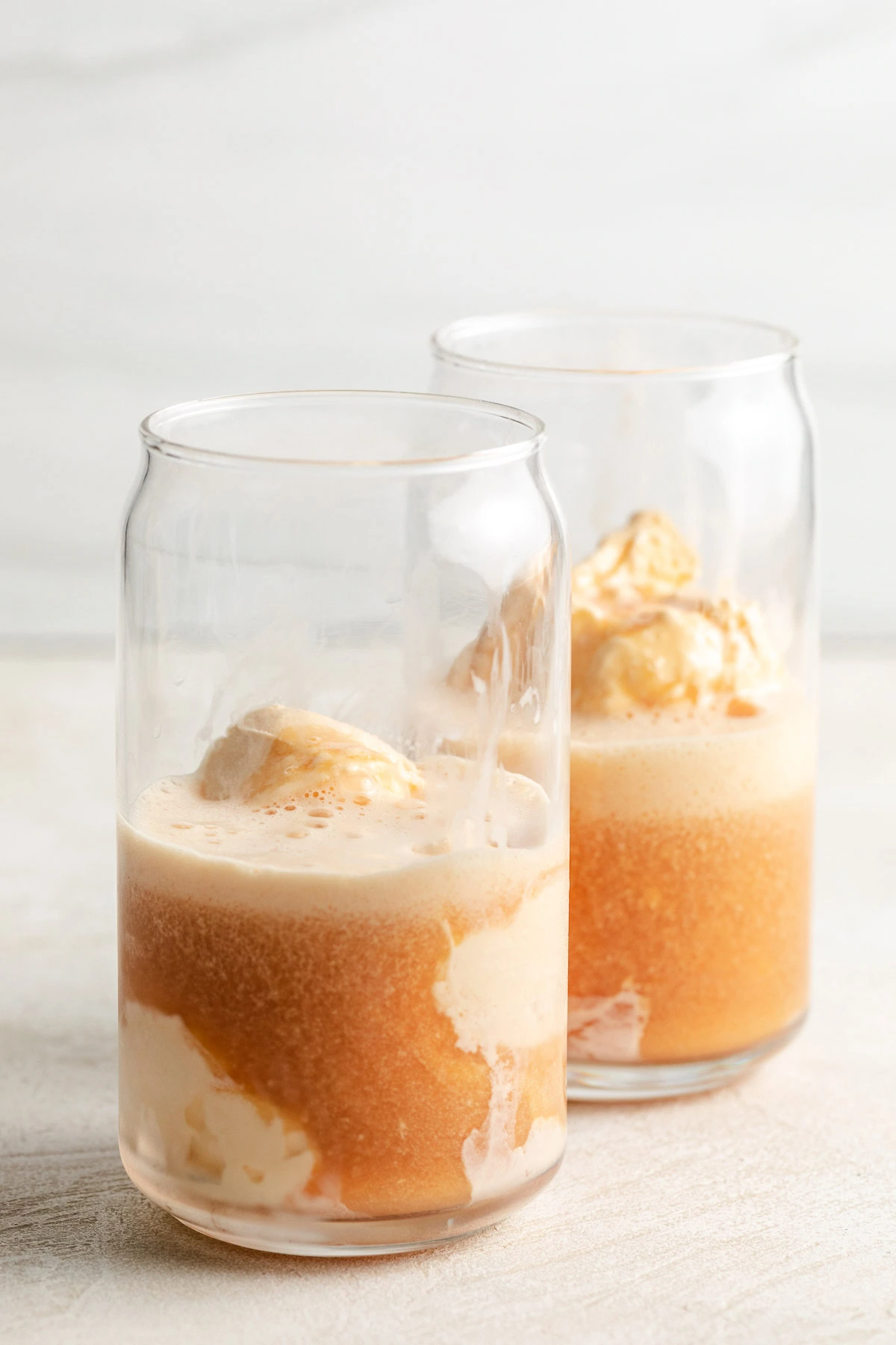 Cranberry and orange juice poured over ice cream.