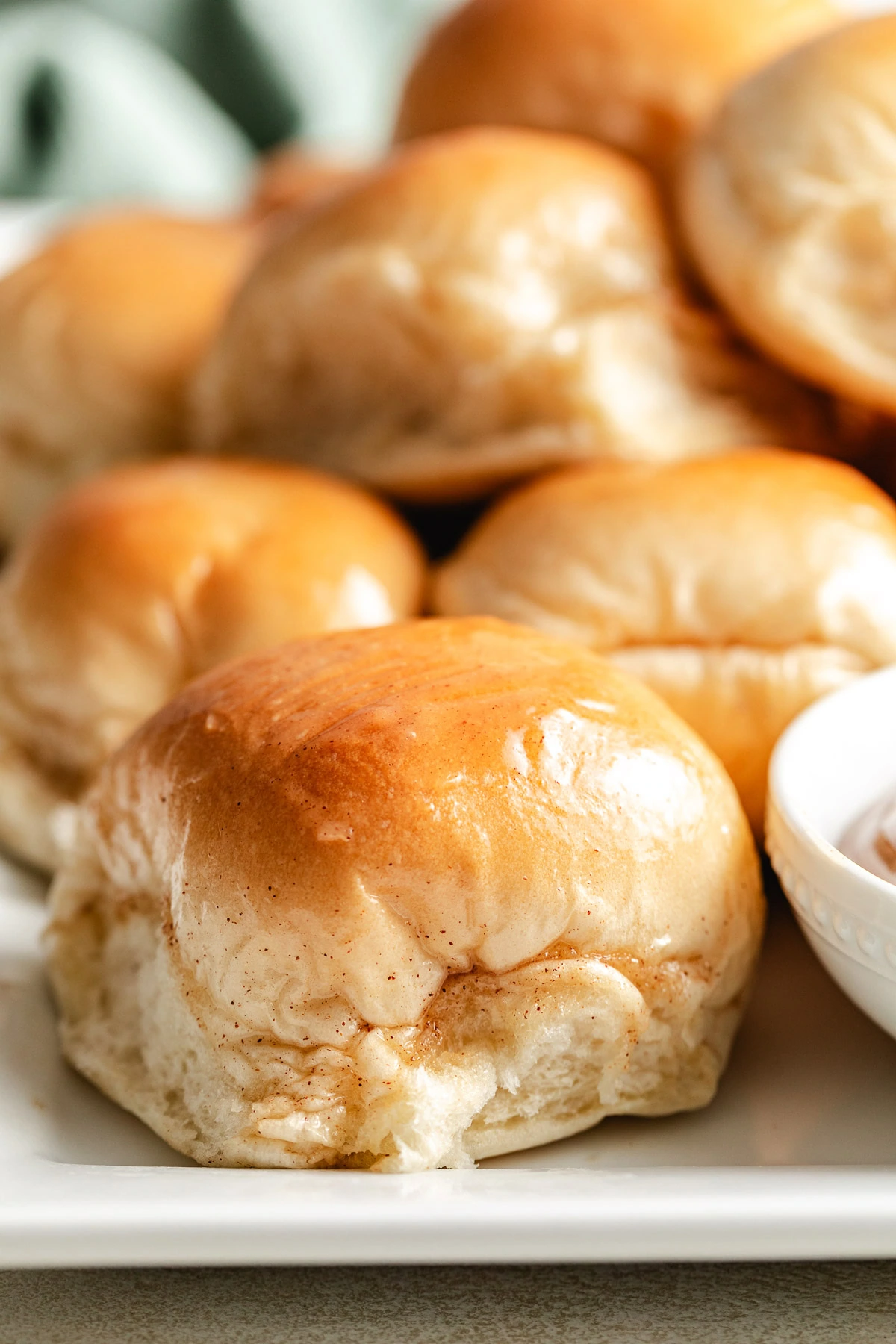 Rolls with honey butter glaze on a platter.