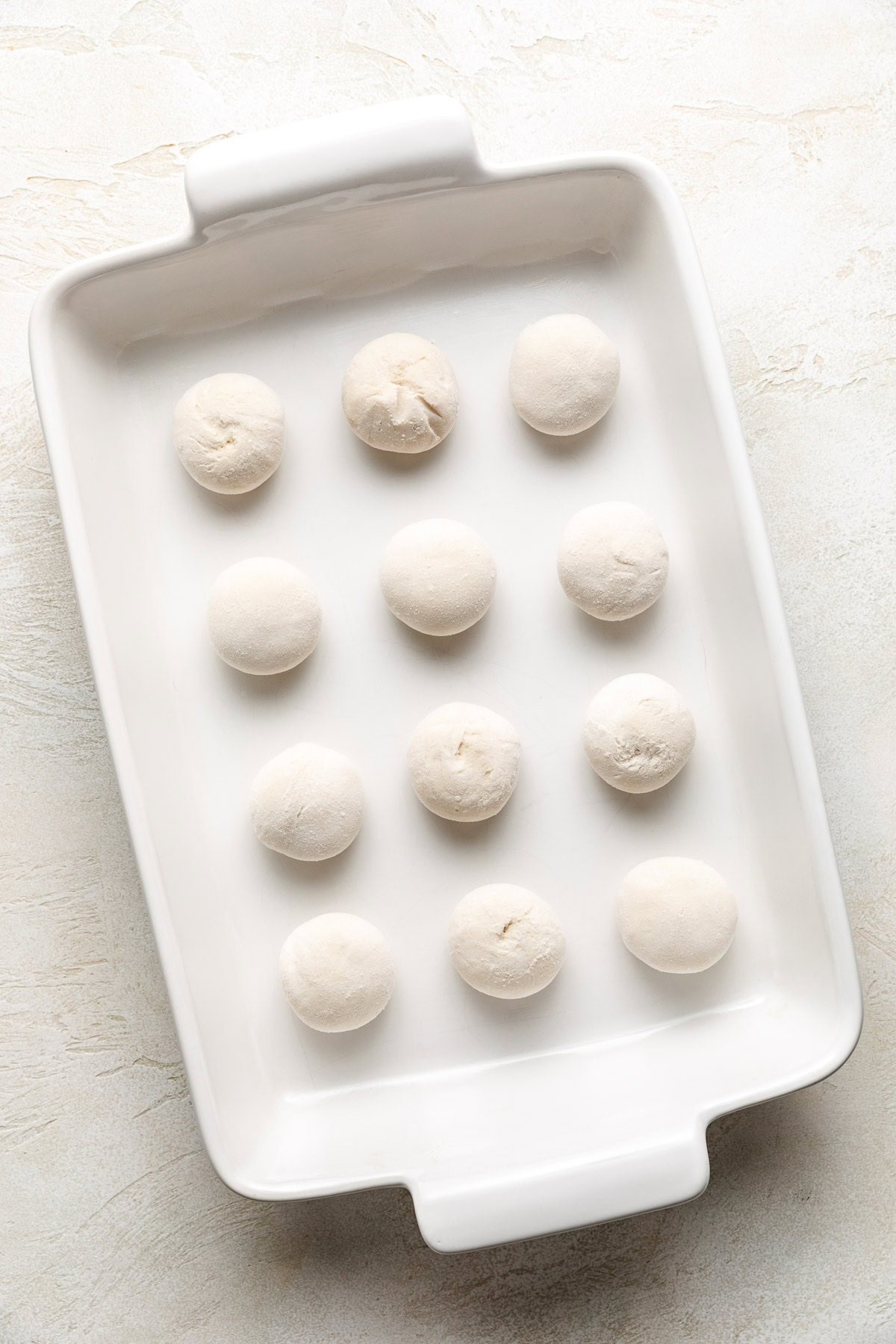 Frozen roll dough in a pan.