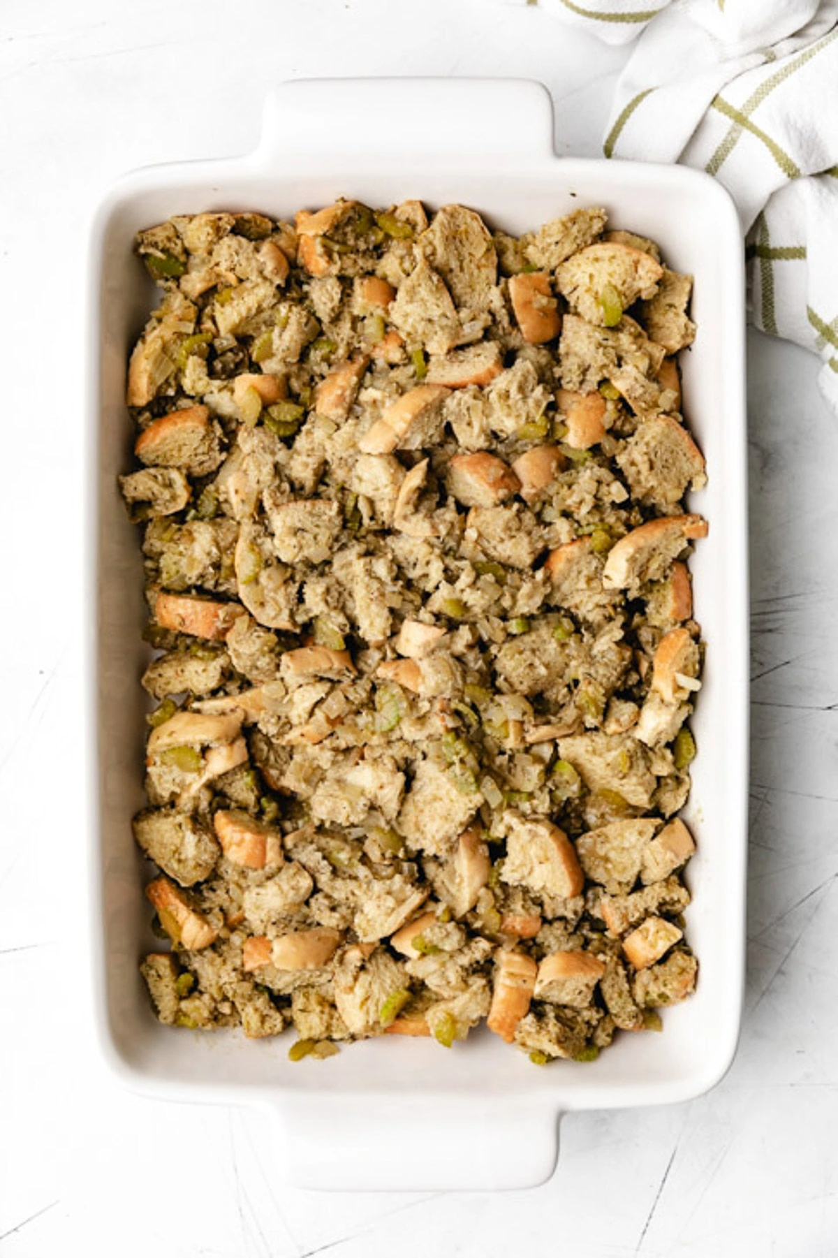 Overhead view of unbaked stuffing in a pan.