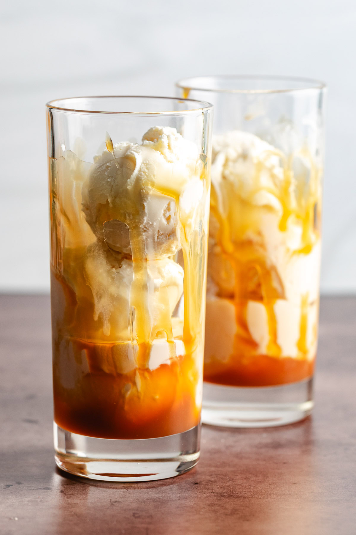2 Ingredient Apple Cider Floats Caramel and ice cream in glasses.