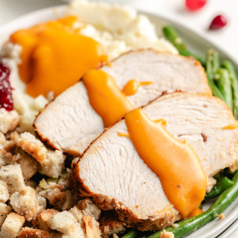 Close up view of cajun turkey breast with gravy.