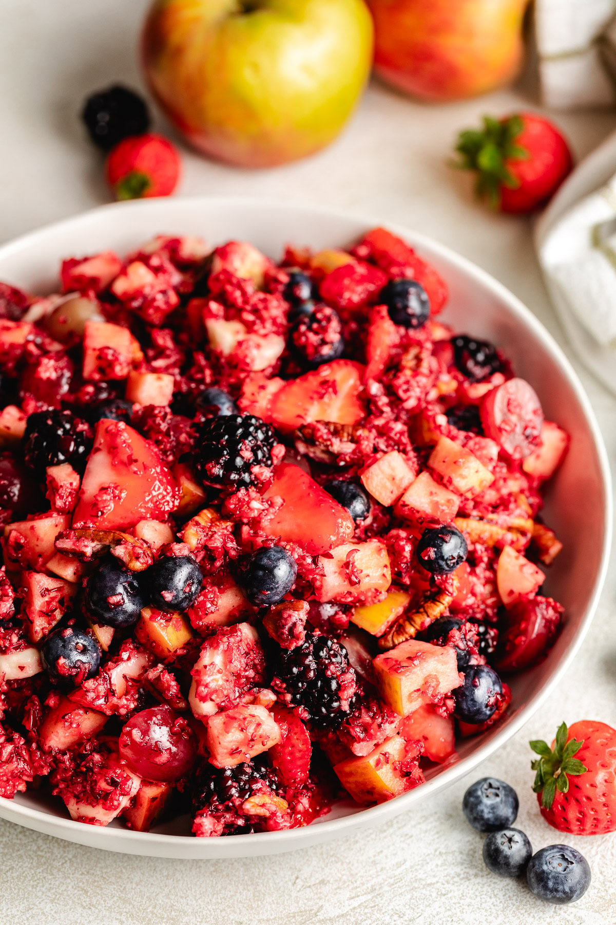 White dish filled with cranberry salad.