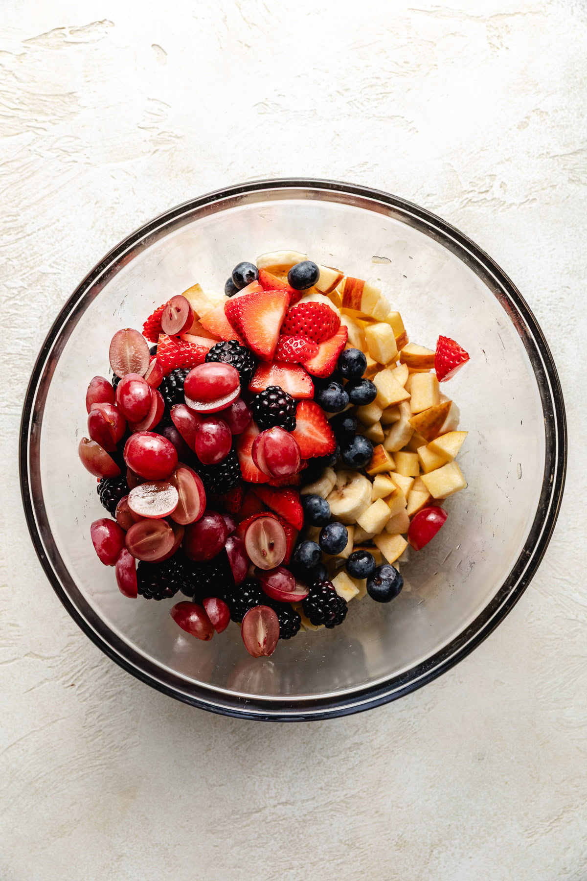 Easy Cranberry Fruit Salad Chopped up fresh fruit in a glass bowl.