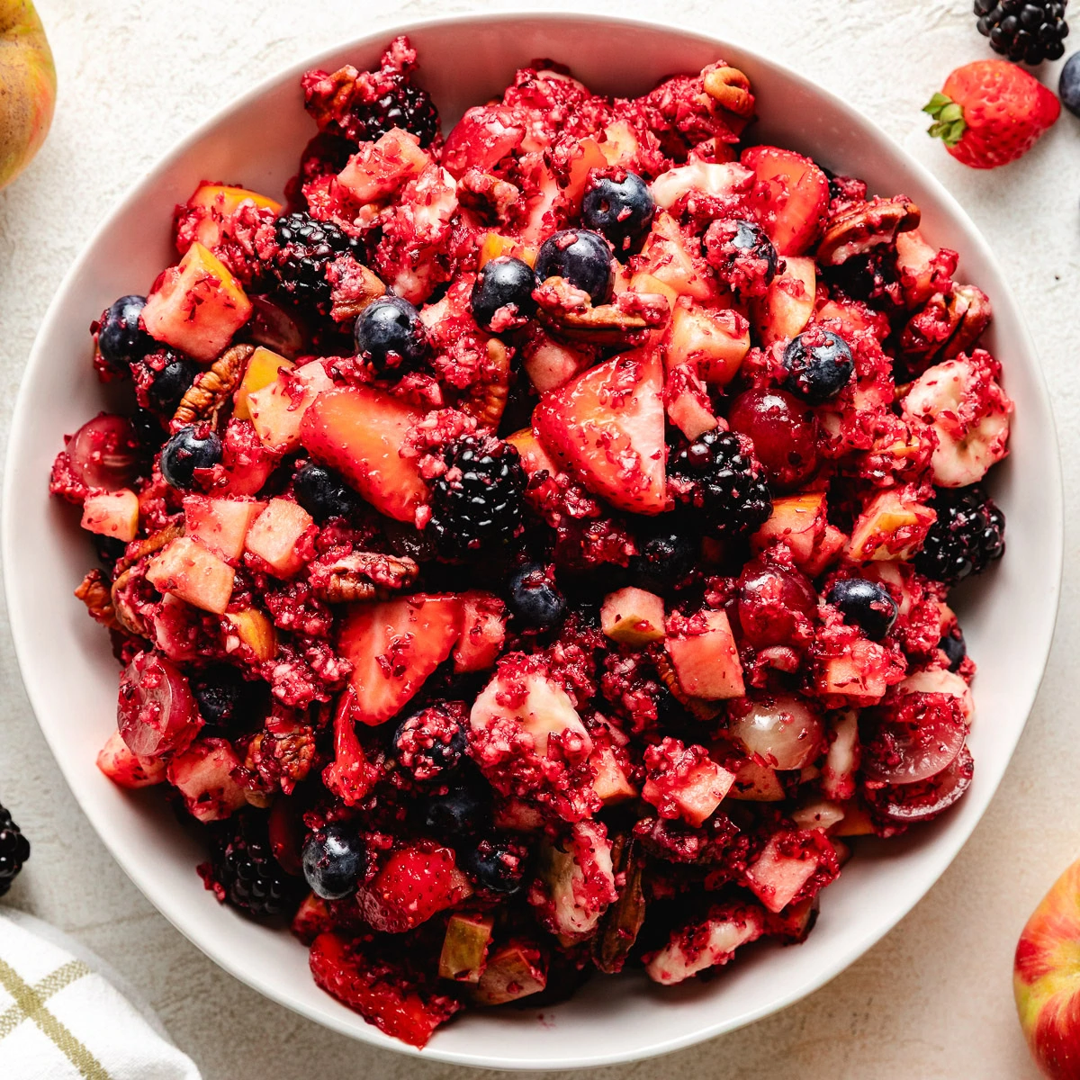 White dish full of cranberry fruit salad.