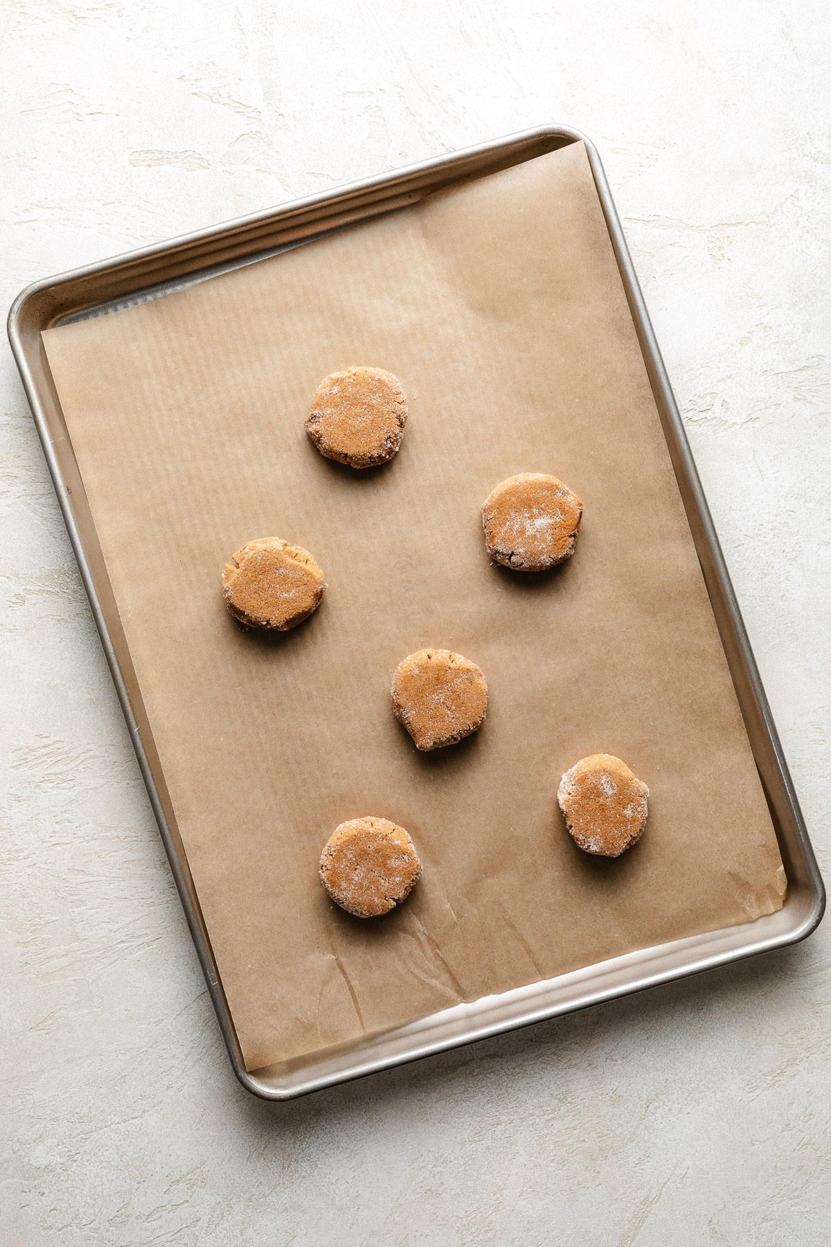 Soft And Chewy Ginger Cookies Baking tray with unbaked cookie dough.