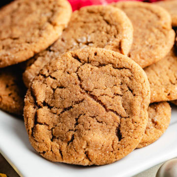 Soft And Chewy Ginger Cookies Ginger cookies stacked together on a plate.