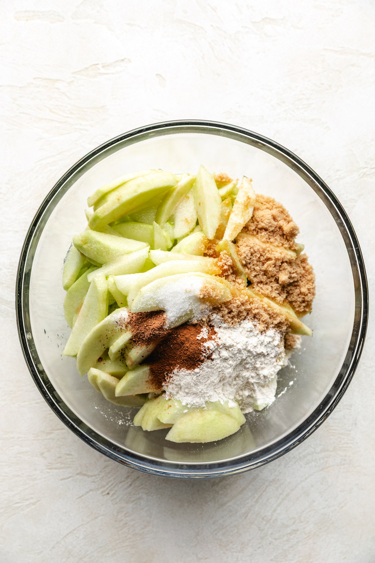 Southern Apple Pie Bowl of sliced apples, sugar, cinnamon, and flour.