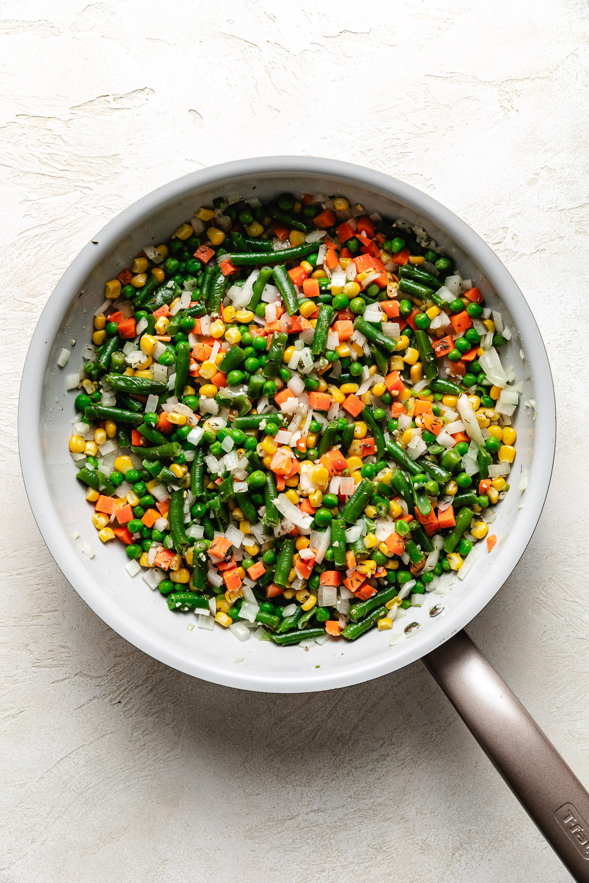 Sauteed veggies in skillet.