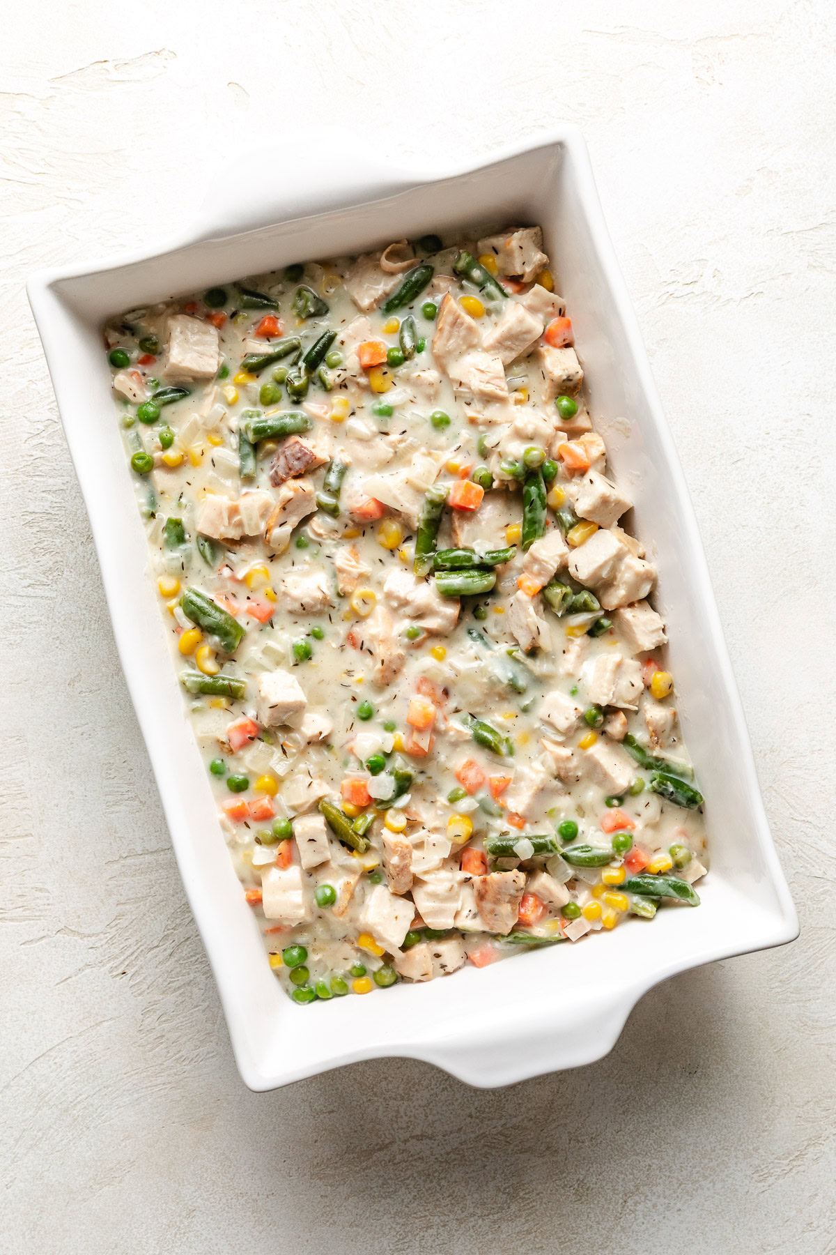 Pot pie filling in a casserole dish.