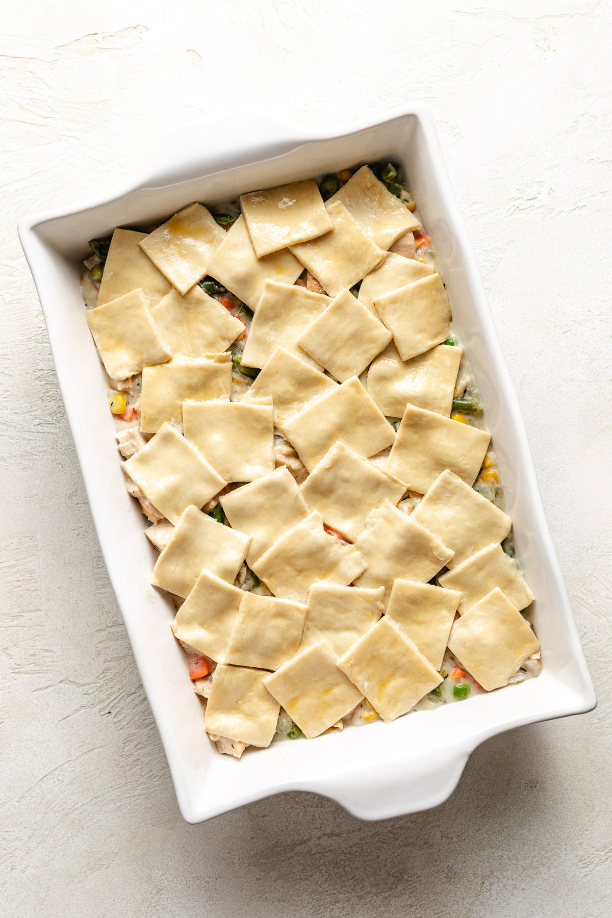 Puff pastry squares added to pot pie filling.