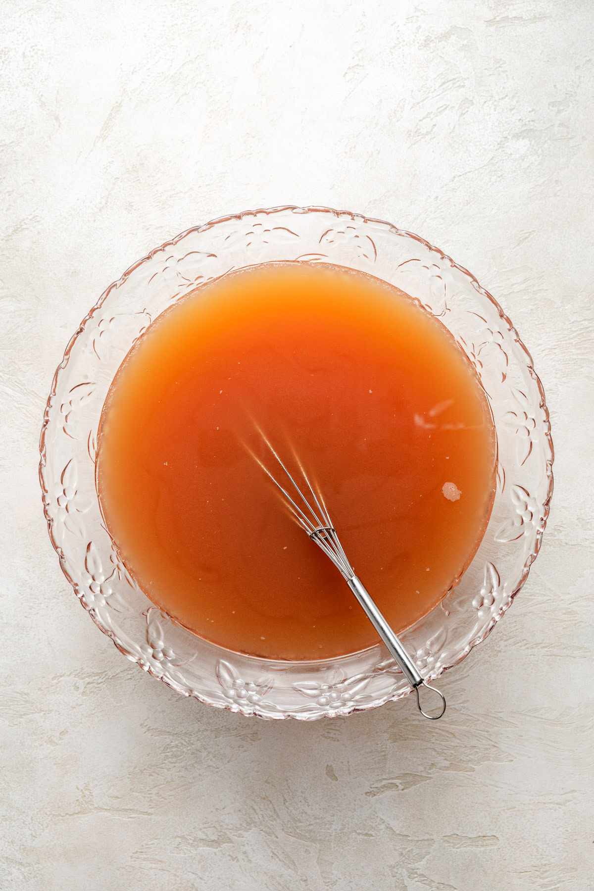 Easy Cranberry Christmas Punch Bowl of punch with a whisk.