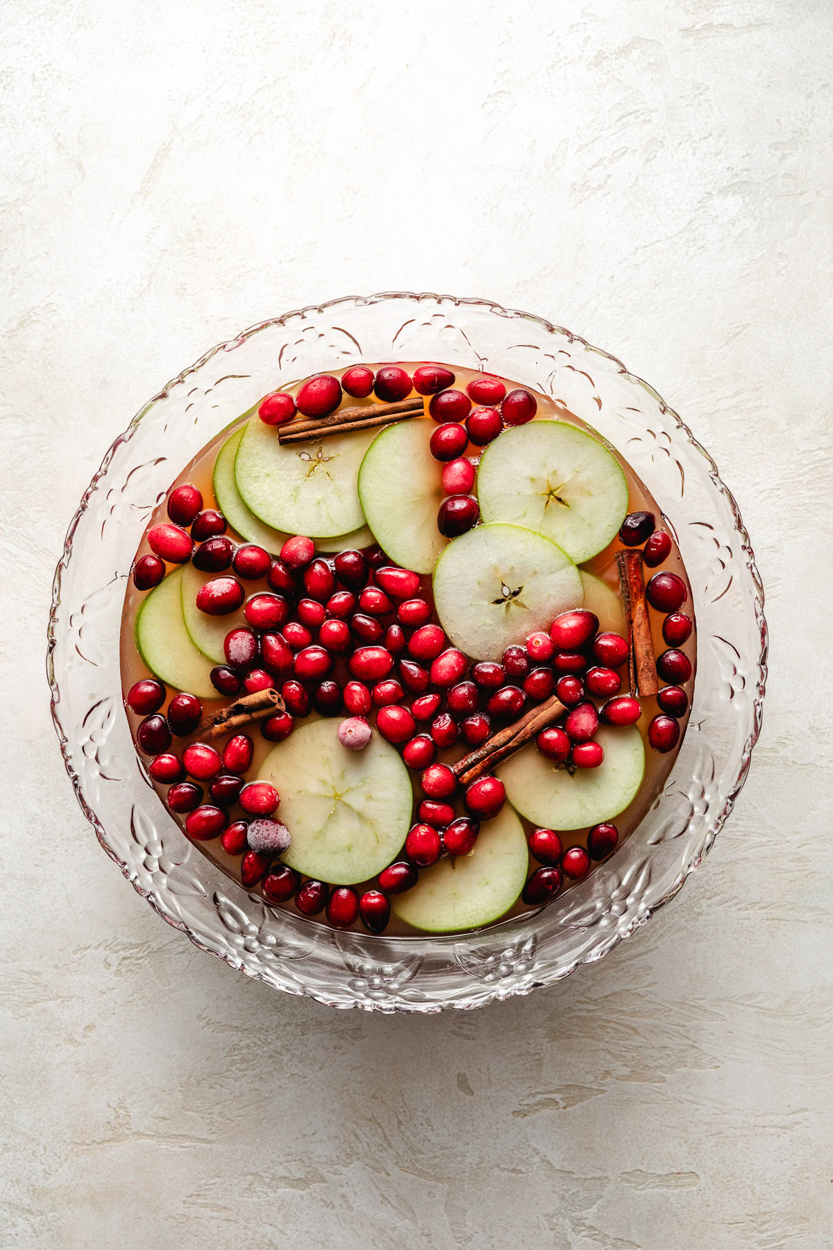 Easy Cranberry Christmas Punch Cranberries and apples in punch bowl.