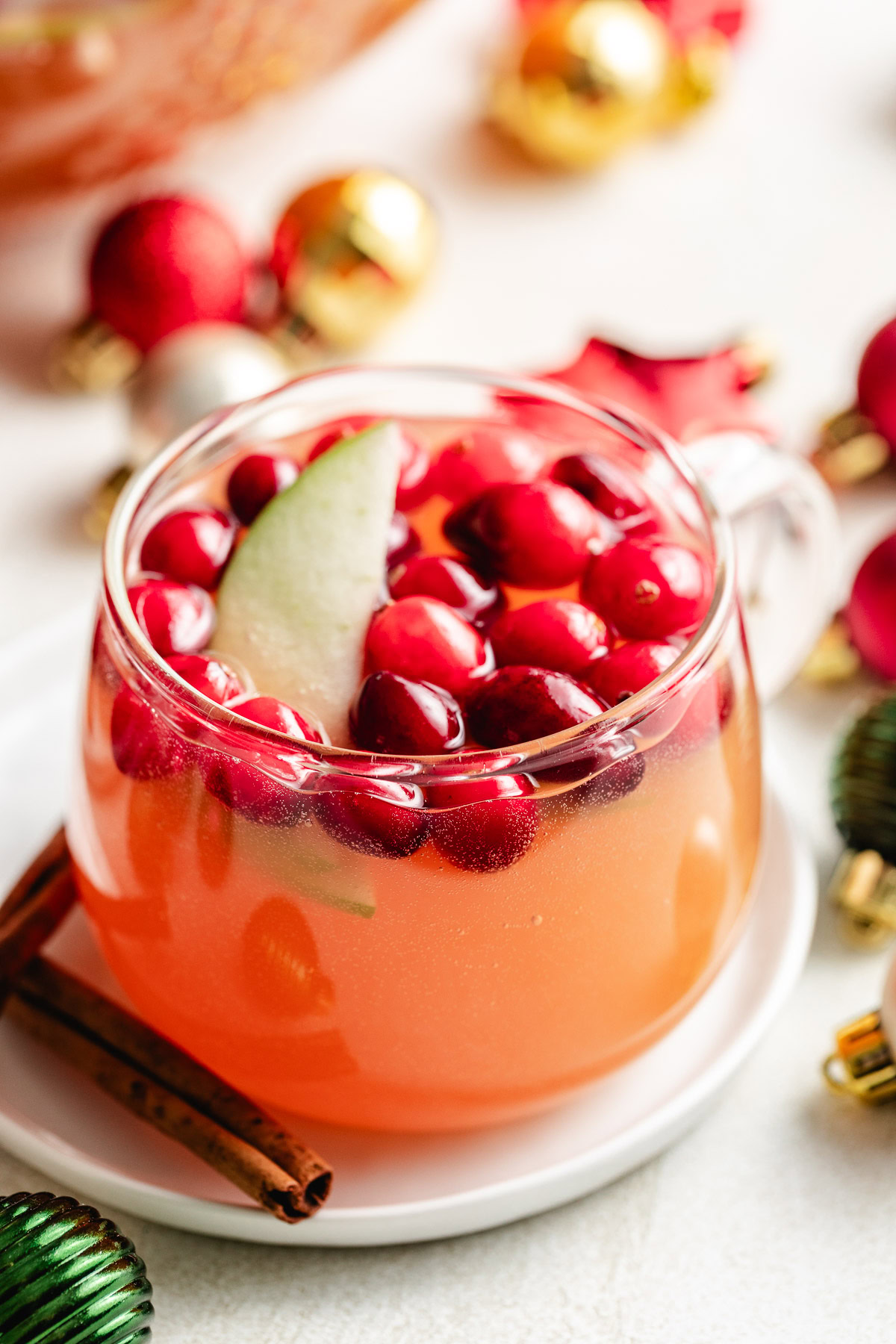 Easy Cranberry Christmas Punch Cranberry punch with an apple slice.