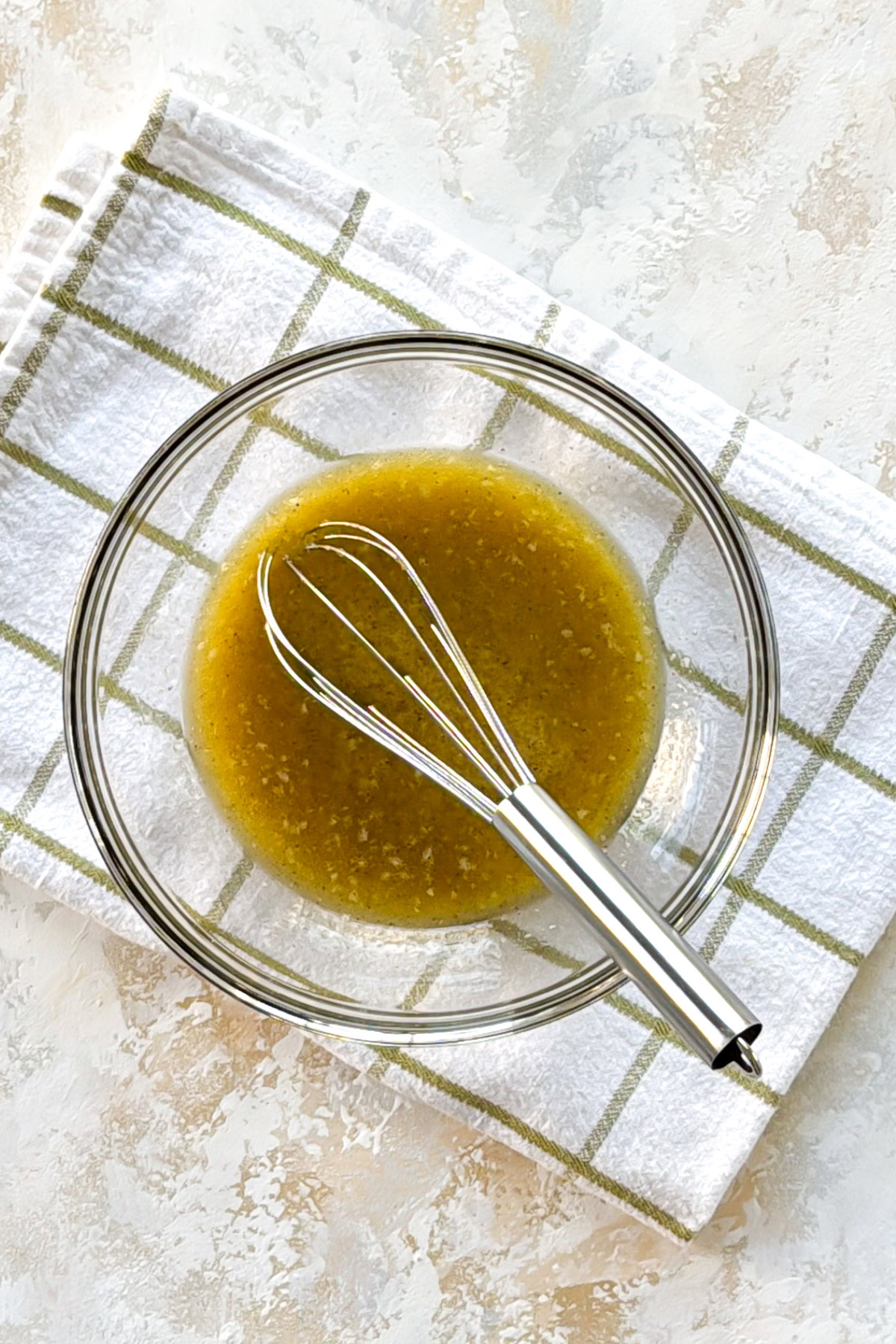 Lemon Garlic Butter Baked Cod Whisk in bowl with lemon garlic butter.