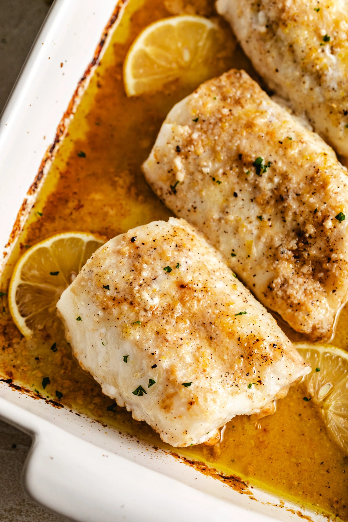 Lemon garlic butter baked cod in a baking dish.