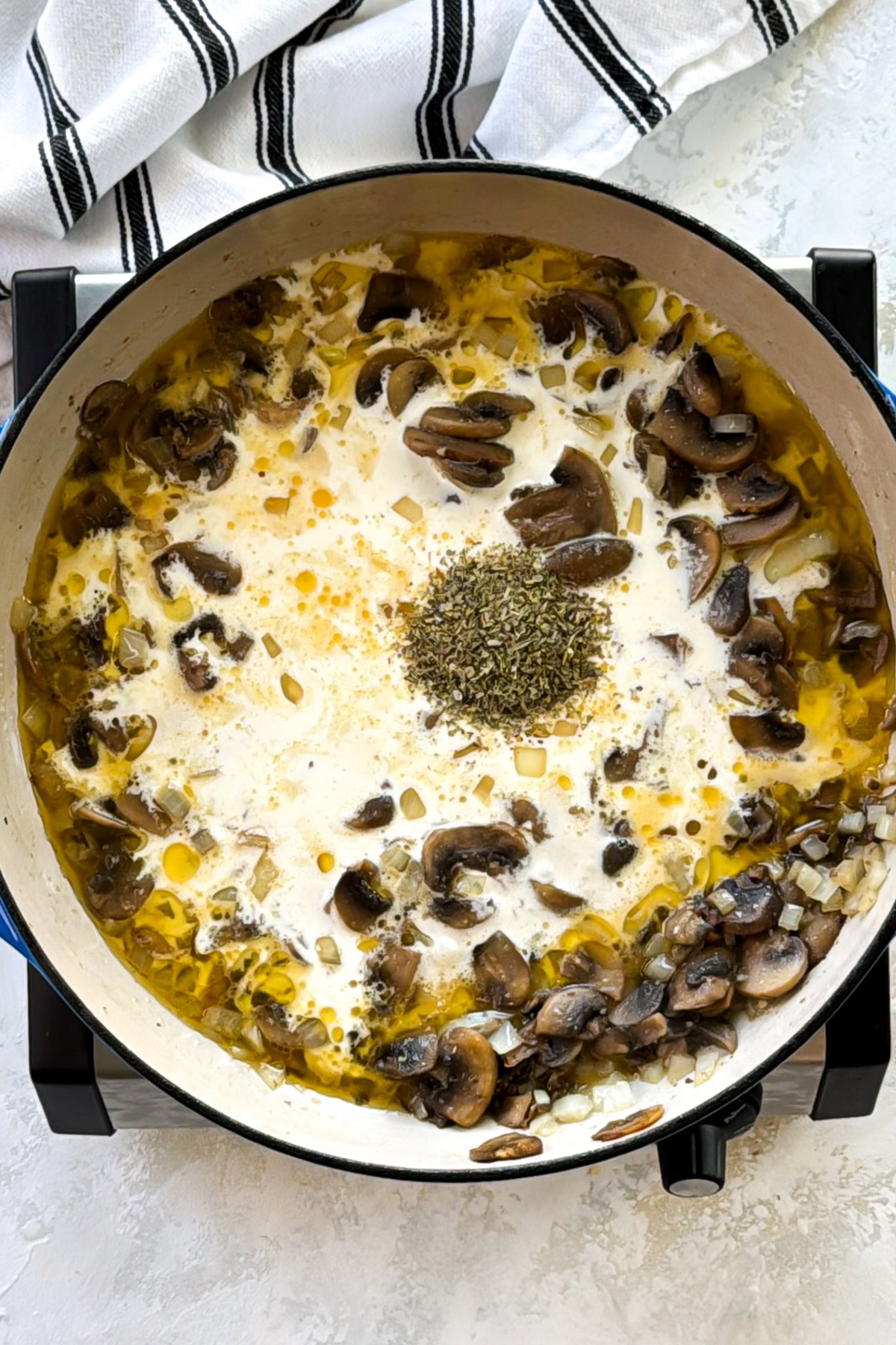 Cream added to mushrooms with herbs.