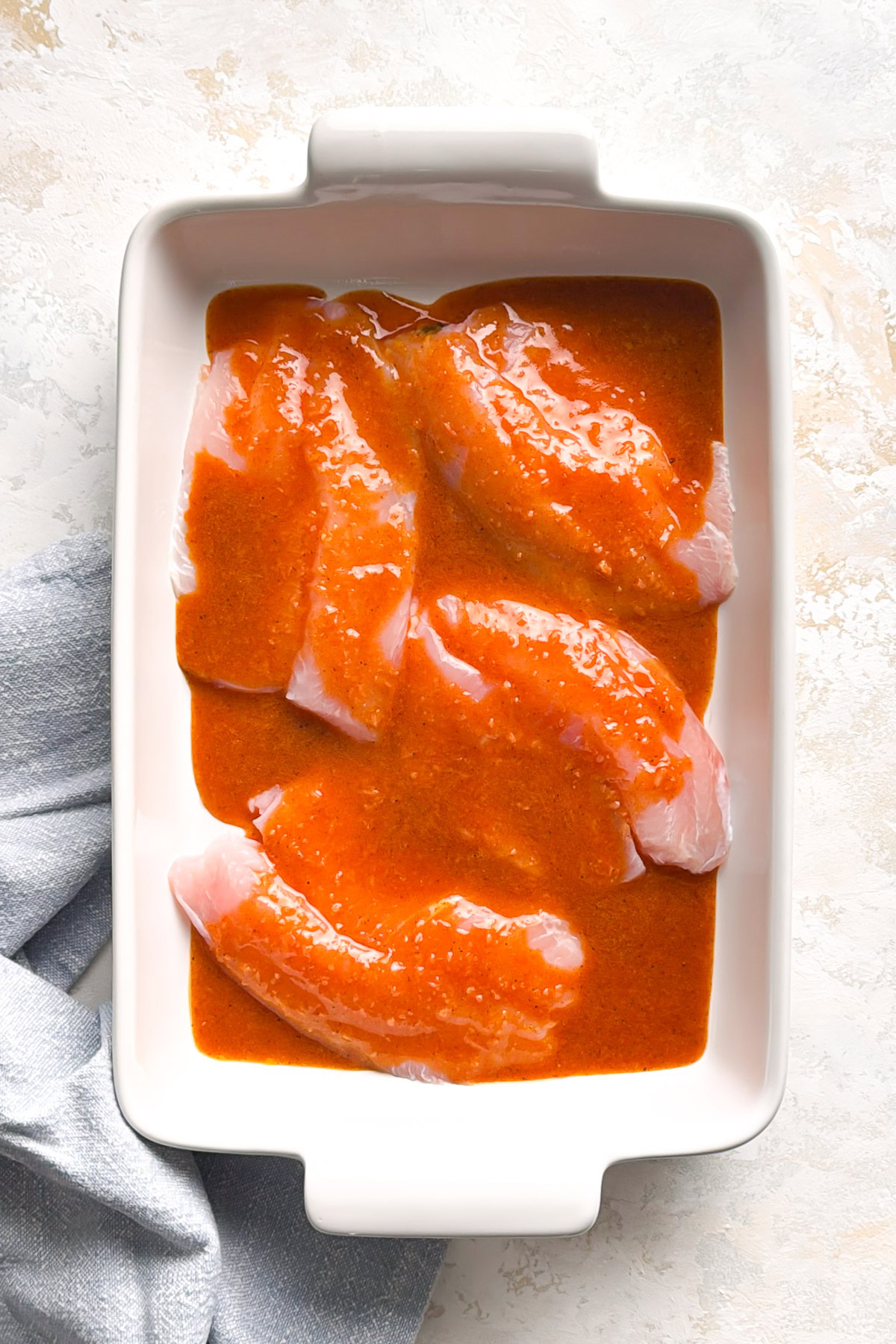 Garlic lemon butter poured over tilapia fillets.