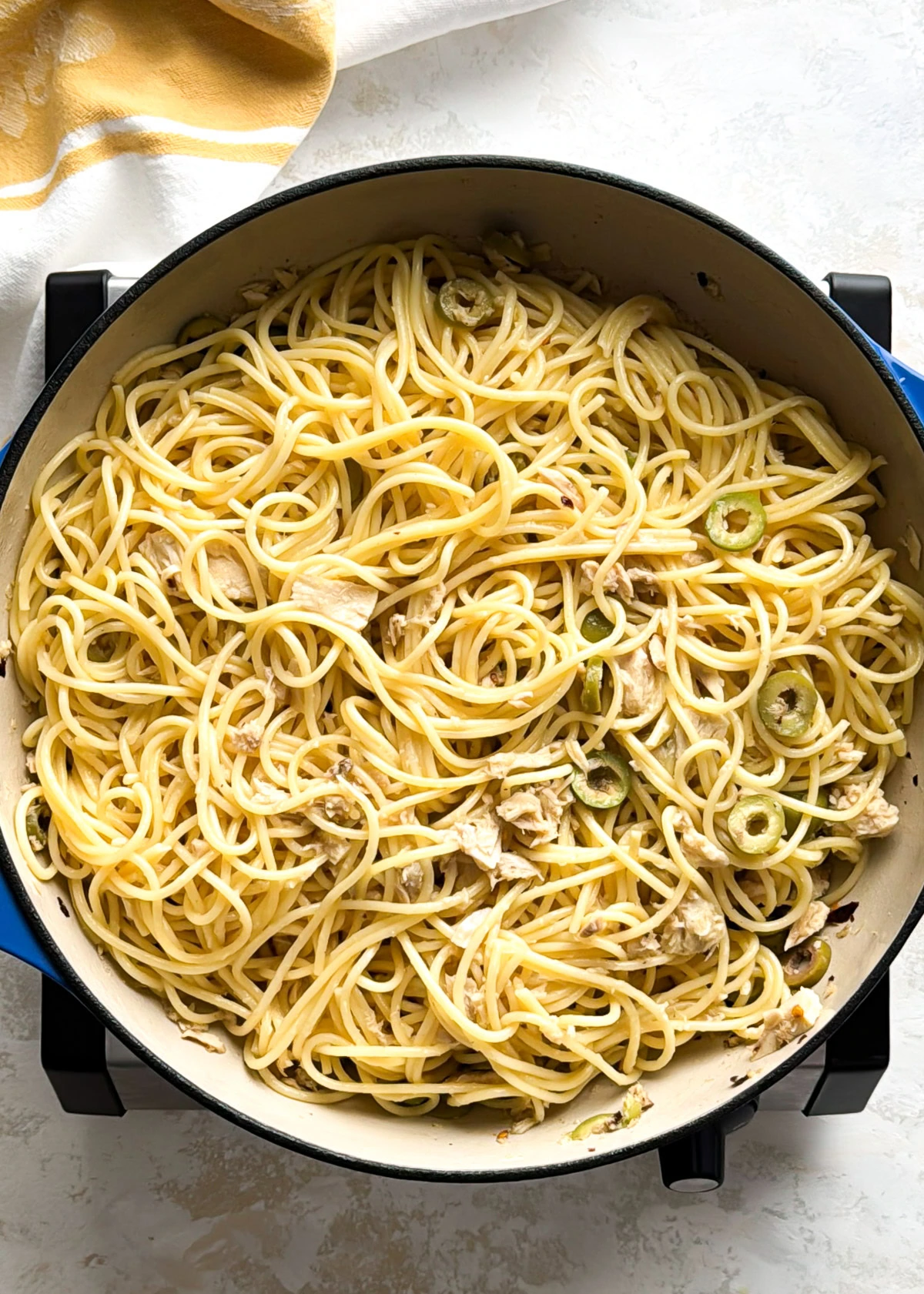 Garlic, red pepper flakes, and salt warming in olive oil in a Dutch oven.