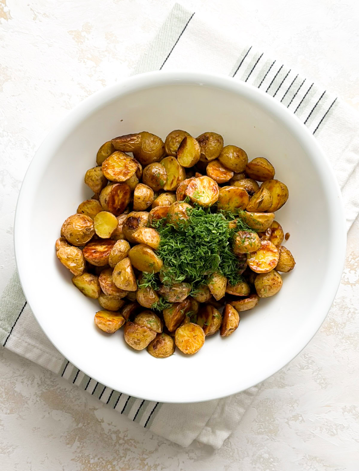Roasted dill potatoes topped with chopped fresh dill.