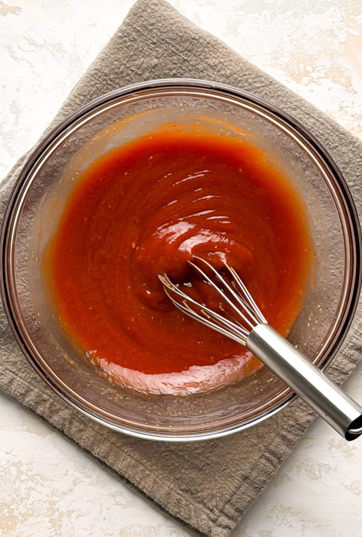 Smooth red cocktail sauce in a glass bowl after whisking.