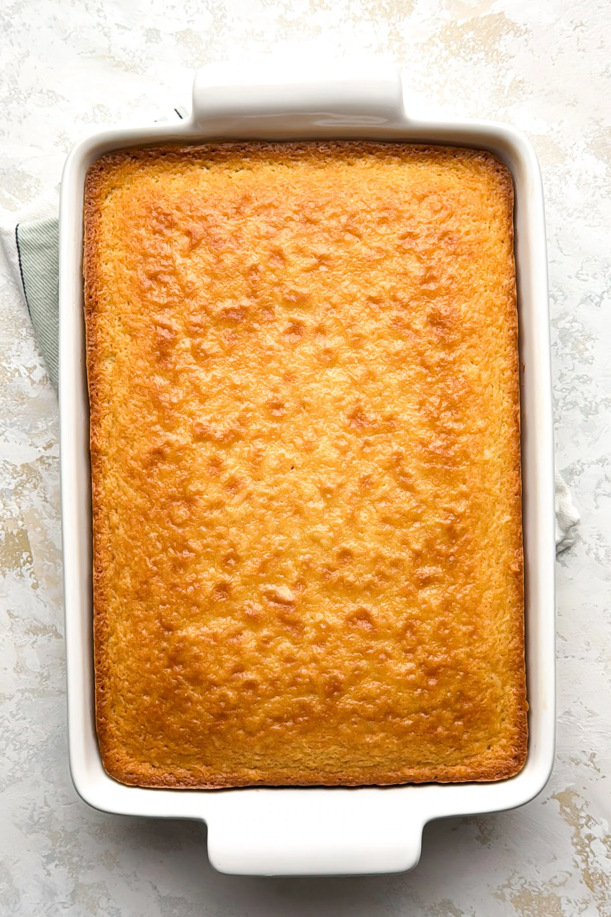 Baked coconut cake cooled in the baking dish.
