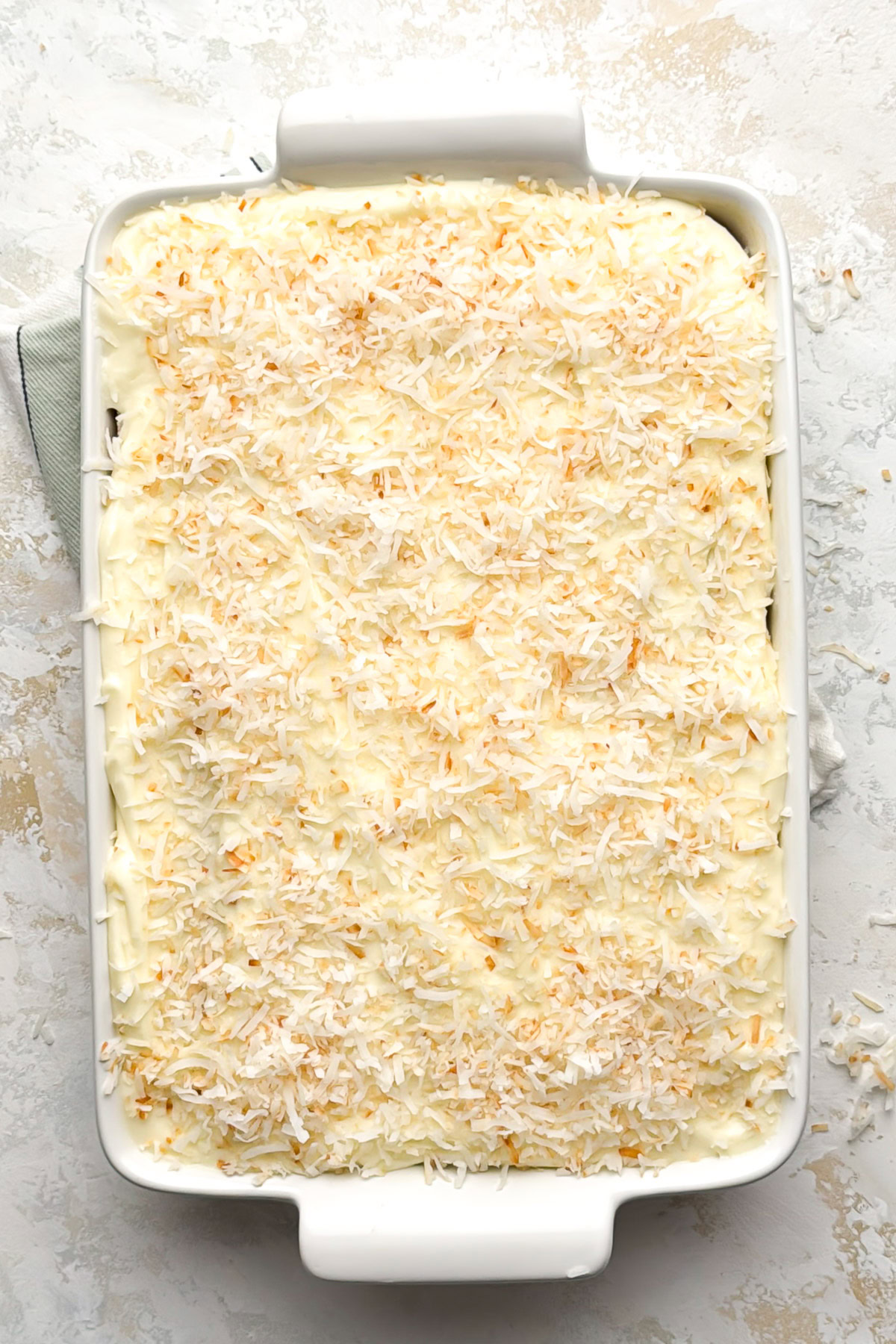 Frosted cake topped with shredded coconut.