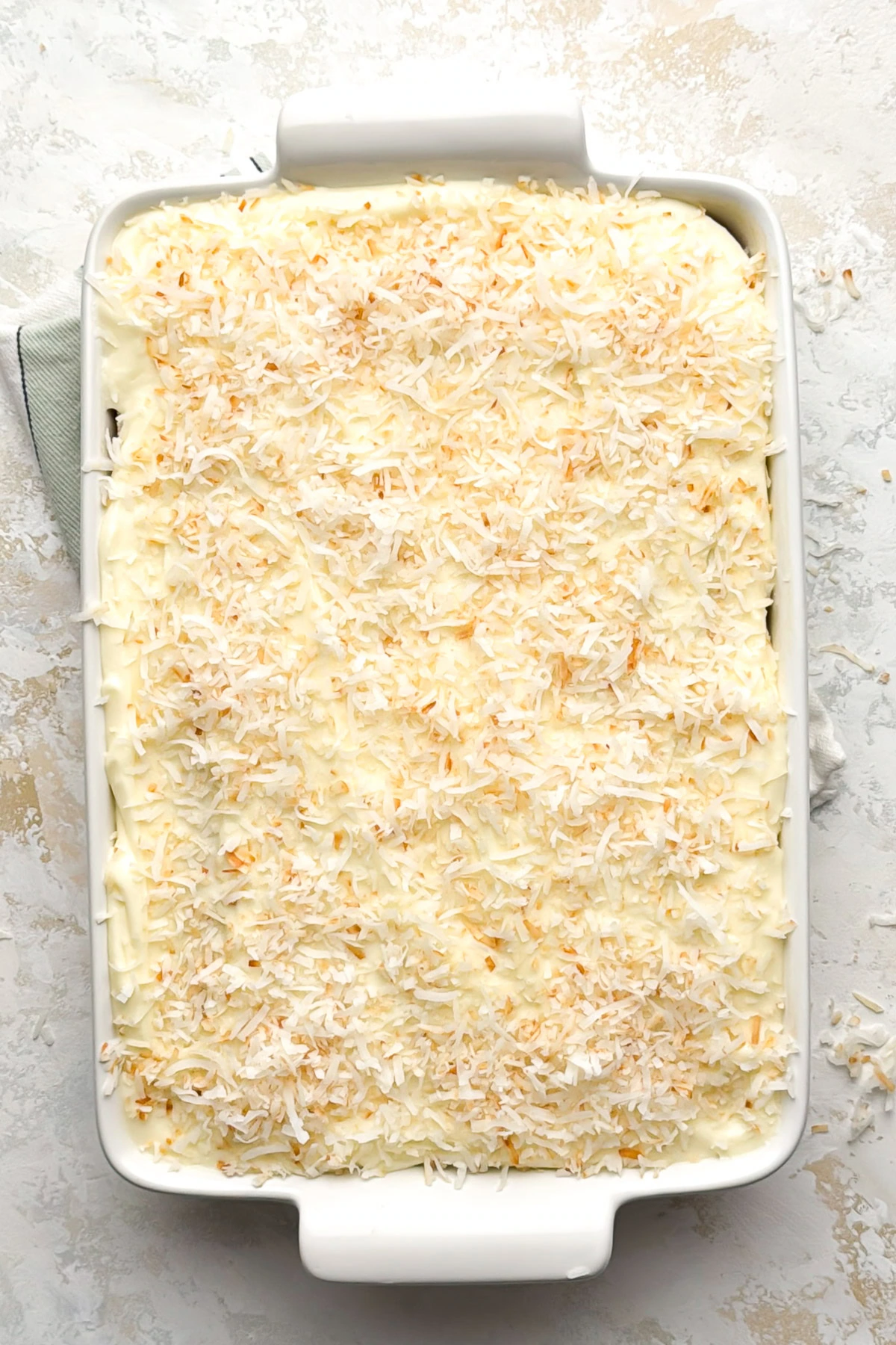 Frosted cake topped with shredded coconut.