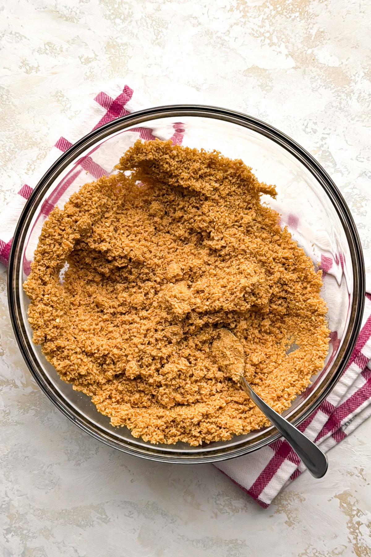 Crumb mixture stirred together in a glass mixing bowl.