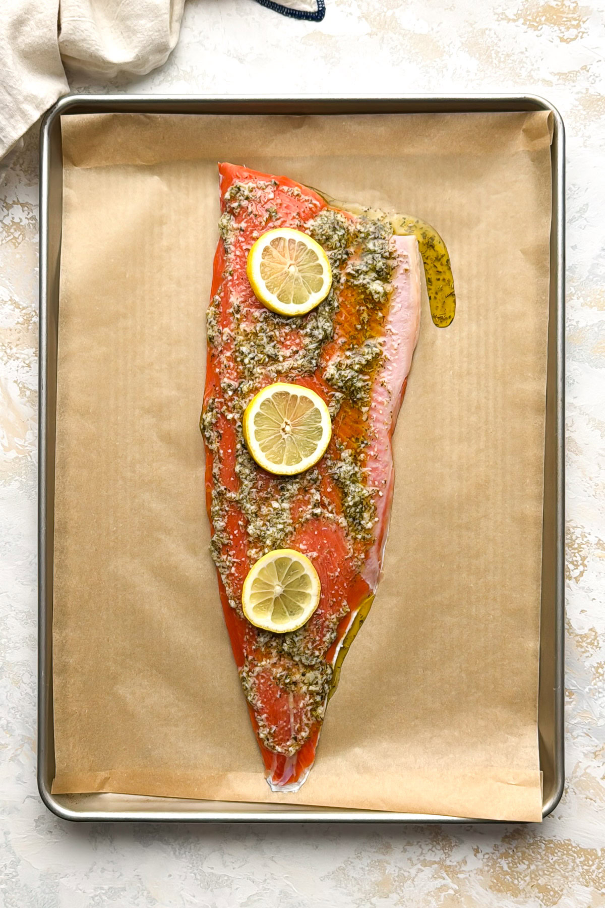 Garlic herb butter spread over salmon.