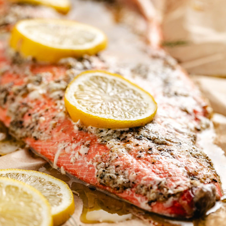 Close up view of baked salmon with lemon.